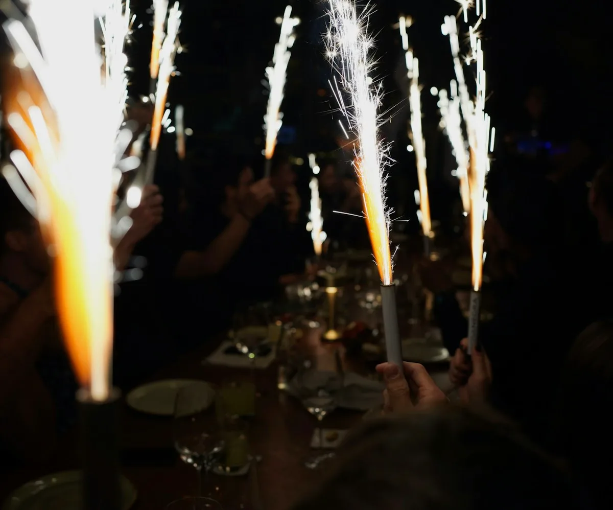 Birthday dinner table lit by sparklers